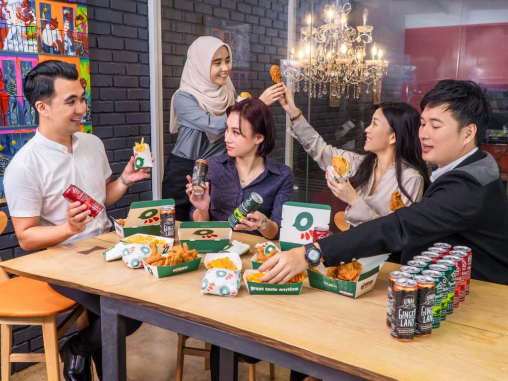 A group of colleagues enjoying takeaway Borenos Fried Chicken